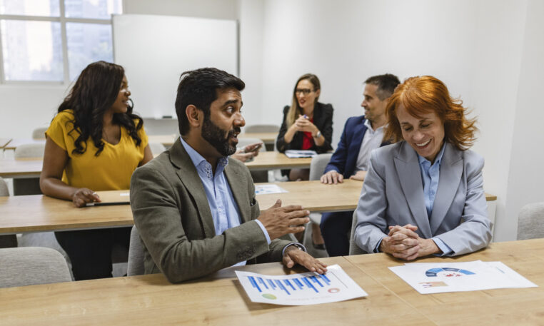 Multiracial Business Team Engaging in Informal Discussion During Workshop
